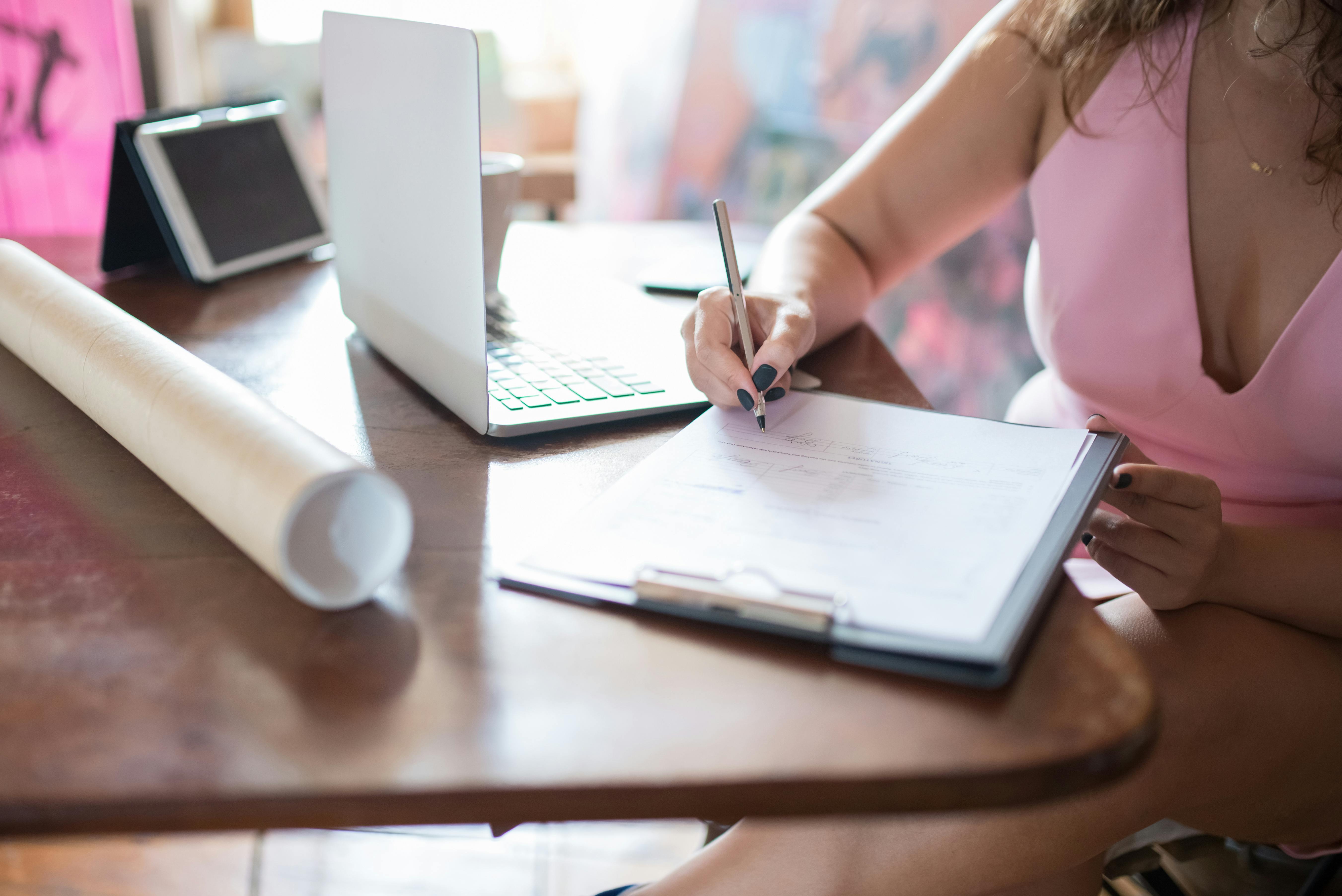 Premium Photo  A woman writes in a square notebook with white