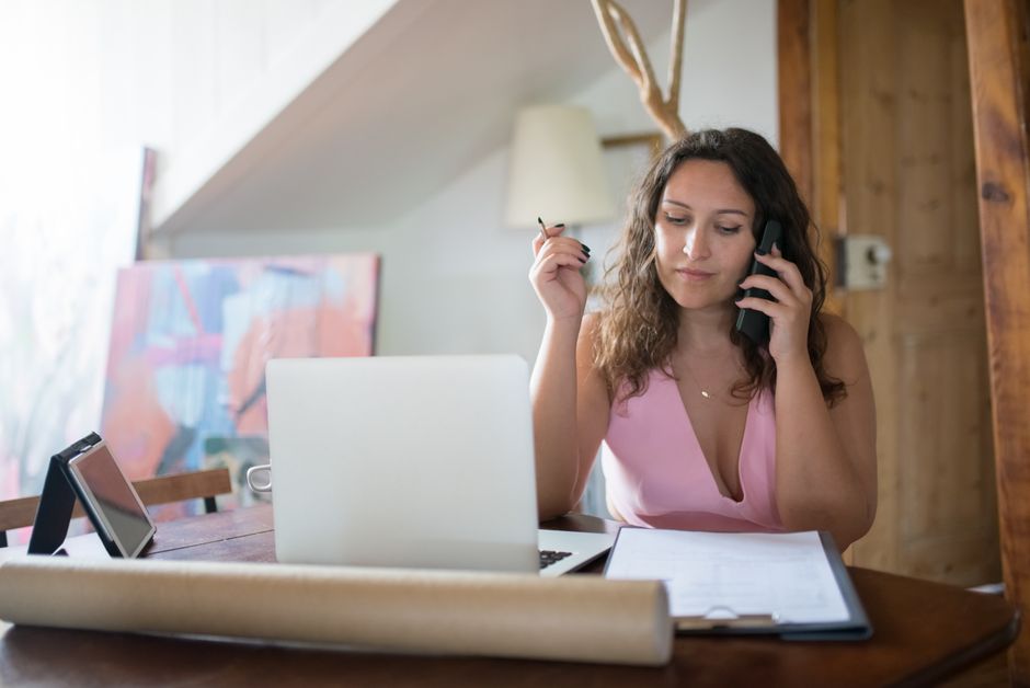 Photo by Kampus Production on Pexels Homeowner on phone call reviewing paperwork at kitchen table