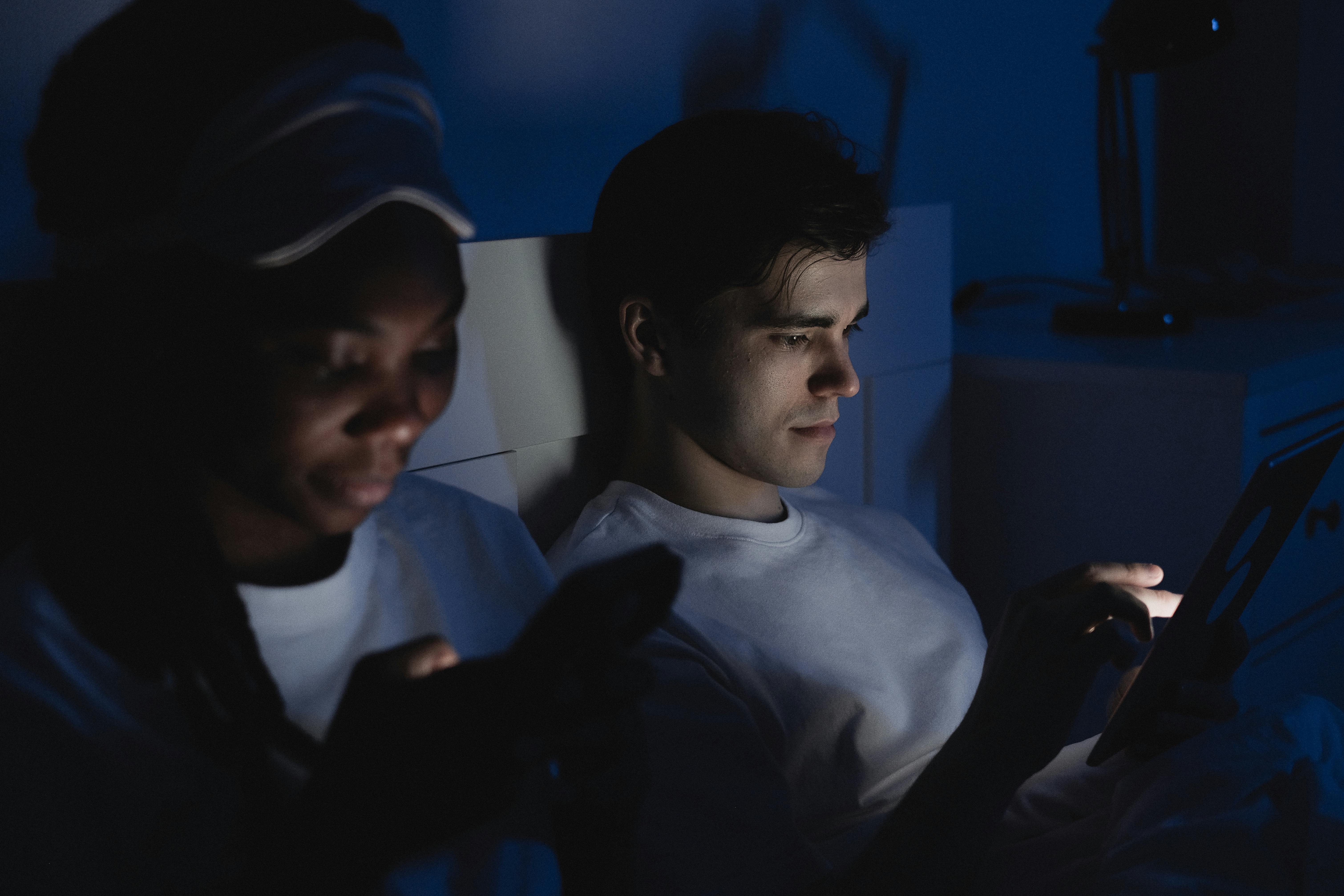 Free Man and Woman Using Mobile Phone in the Dark Stock Photo