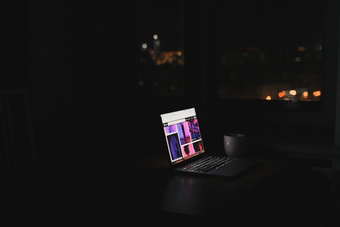 Laptop glowing in a dark room at night, SHVETS production on Pexels