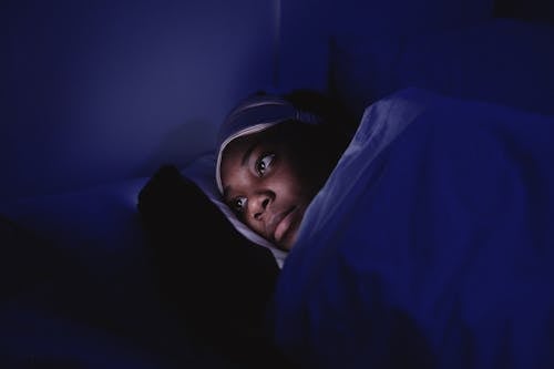 Woman Using a Cellphone during Bedtime