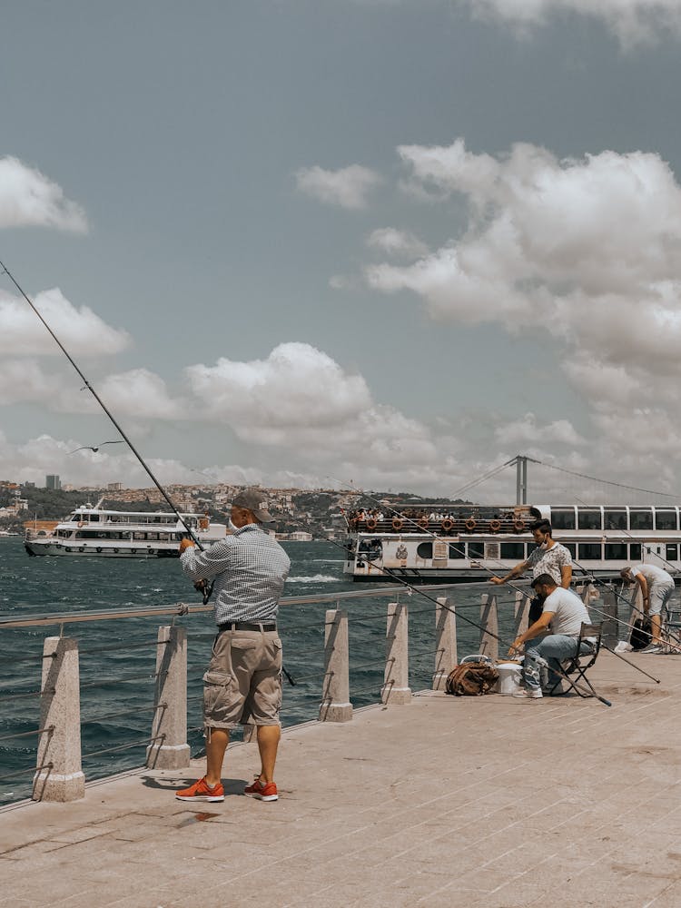 Men Fishing By The Dock