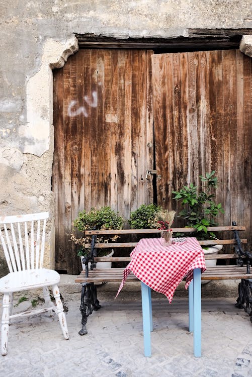 Free Cafe Table next to an Old Wooden Gate Stock Photo