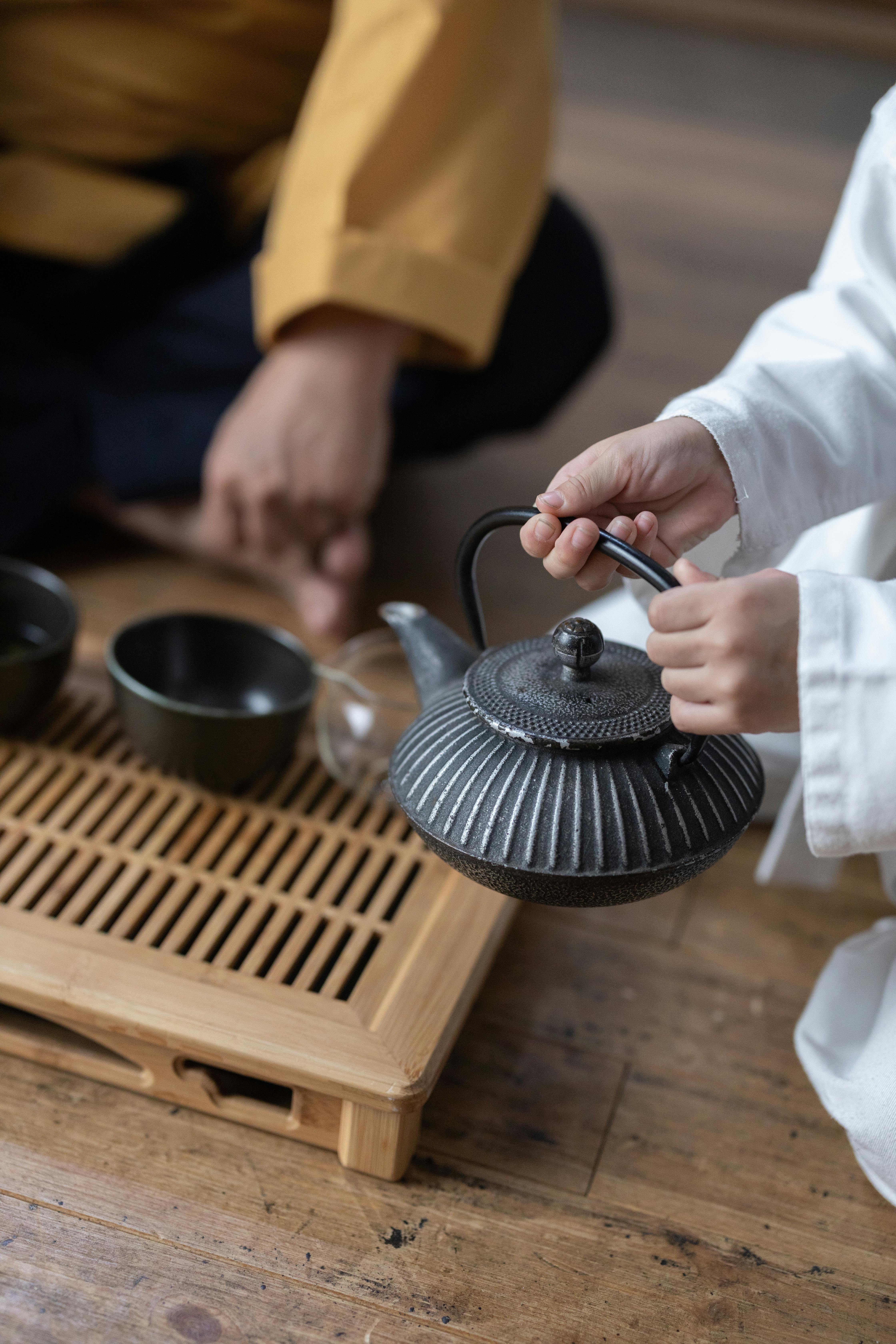 person holding a teapot