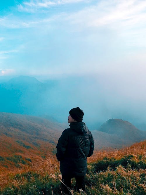 Free Man in Black Jacket Standing on Mountain With Fog Stock Photo
