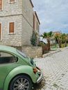 Green Car Parked Beside Brown Brick Building