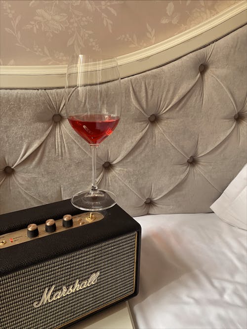 Free A Glass of Red Wine on top of the Speaker Stock Photo