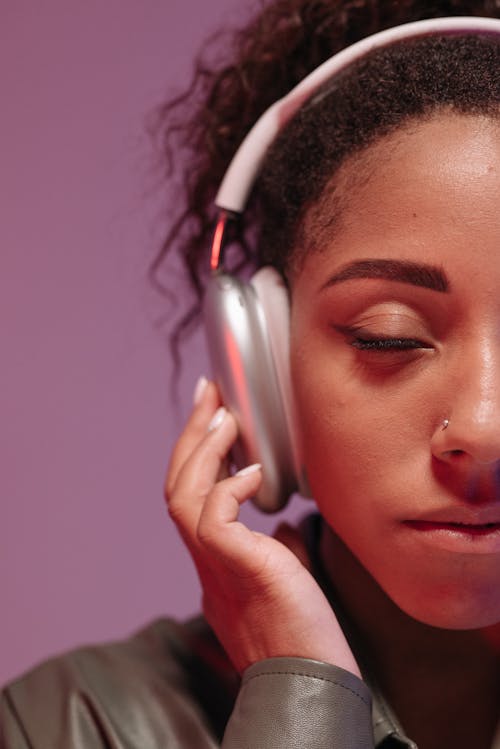 Woman in Gray Long Sleeve Shirt Wearing Gray Headphones