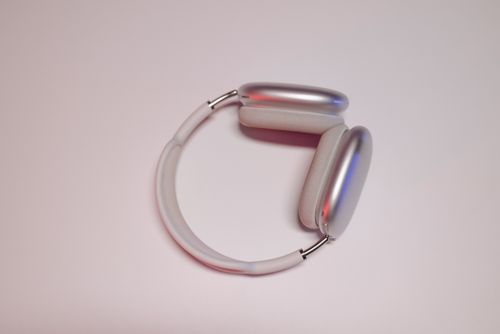 Free Close-up of sleek wireless headphones on a pink background, highlighting modern design. Stock Photo