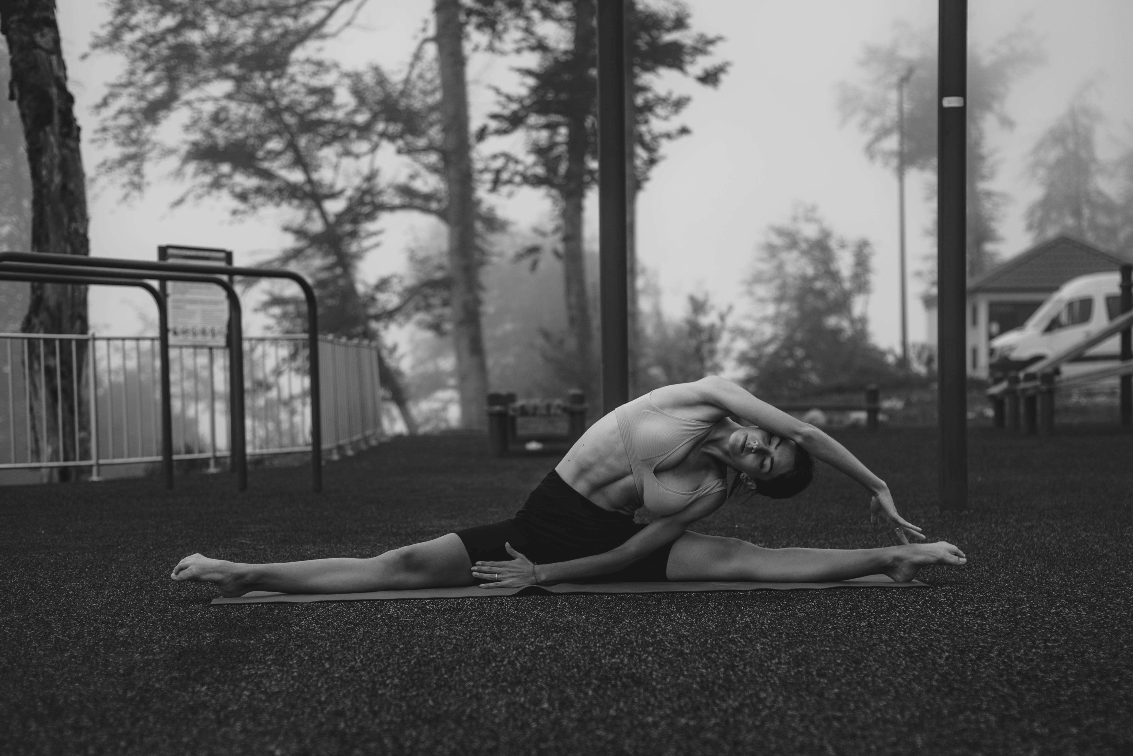 A peaceful nature scene with a person practicing outdoor yoga - wellness practice tips