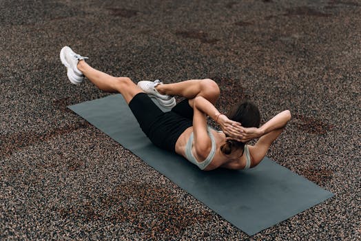 Fit woman doing a bicycle crunch on a mat outdoors, emphasizing core strength and fitness.