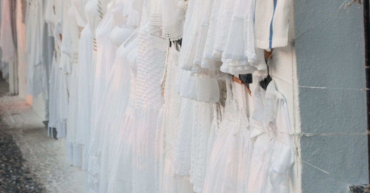 Assorted Dresses Hanged on White Painted Wall
