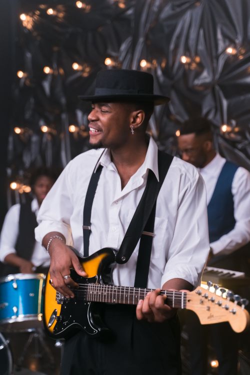 Free Talented musicians perform live with electric guitars and drums, creating an energetic atmosphere. Stock Photo
