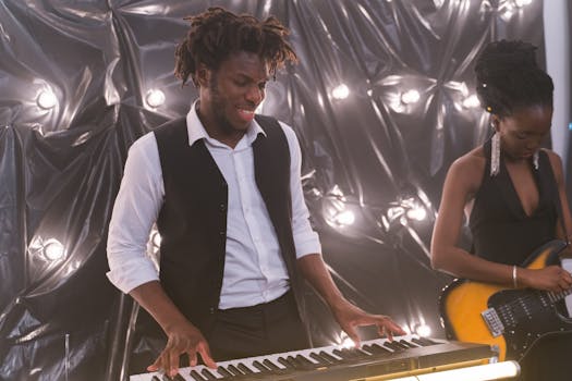 Two musicians performing with passion on keyboard and electric guitar in a vibrant setting.