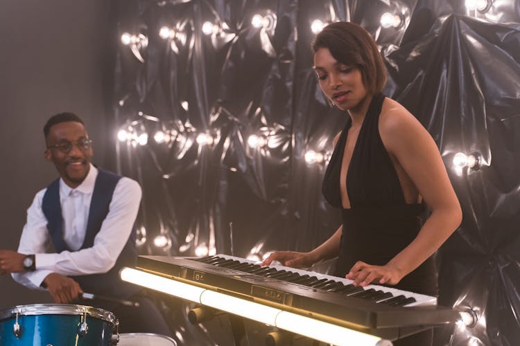 Beautiful Woman In Black Dress Playing The Piano