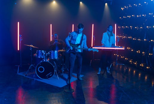 Vibrant live band performance featuring guitar, drums, and synth under neon lights.