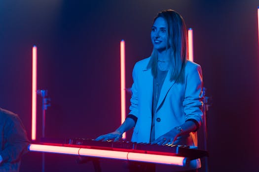 A woman musician enjoys playing keyboard under vibrant neon lights in a modern setting.