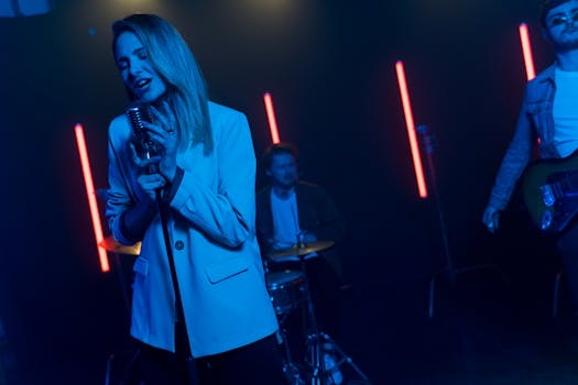 A vibrant band performance with singers and musicians under dramatic neon lighting on stage.