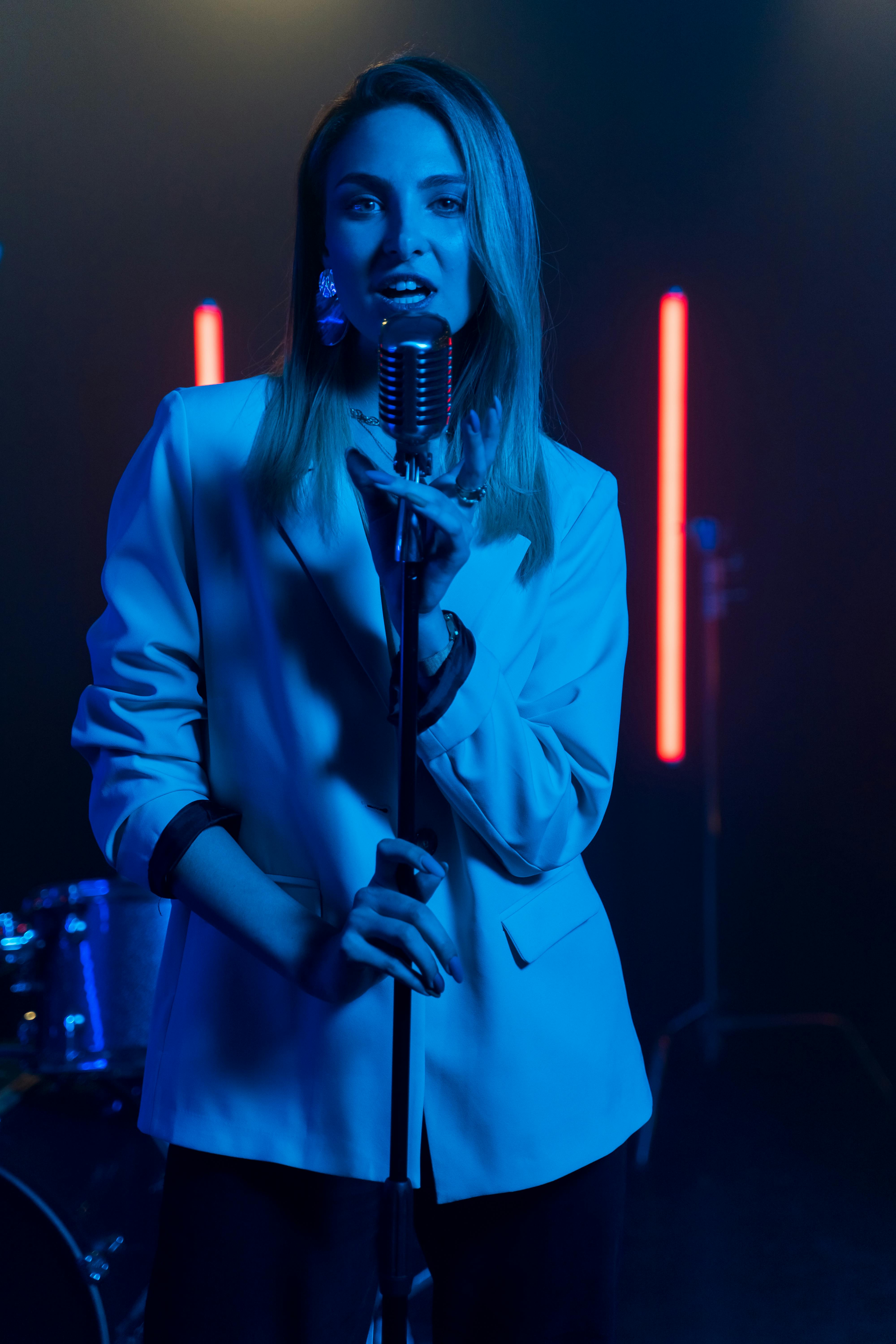 a woman holding a microphone singing