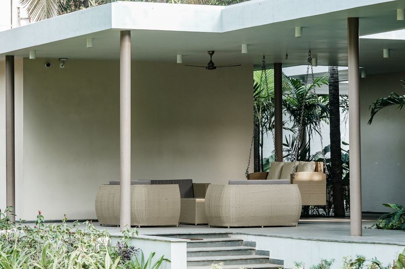 Outdoor patio with modern wicker furniture on pavers