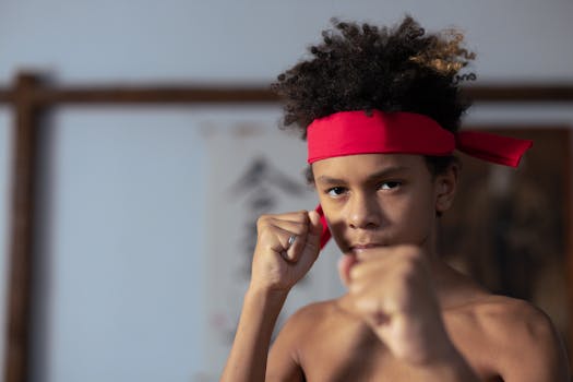 Close-up of a young boy posing martial arts with focus and determination.