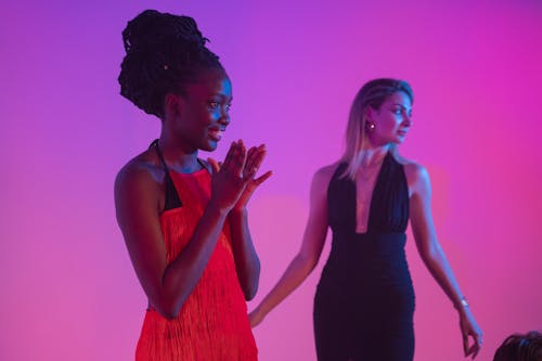 Women Wearing Dresses on Stage