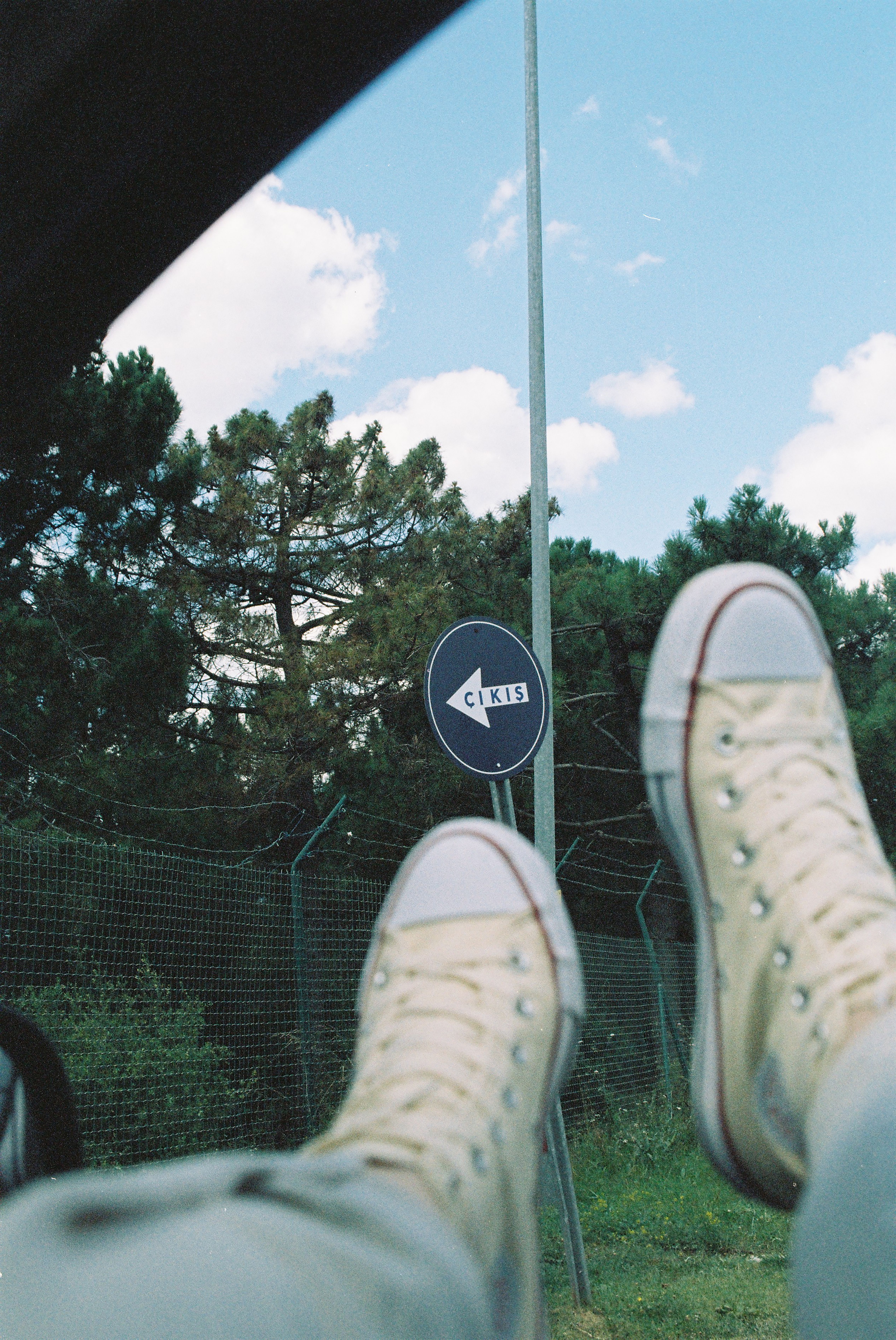 Stylish sneakers against Istanbul's natural backdrop with Cikis sign.