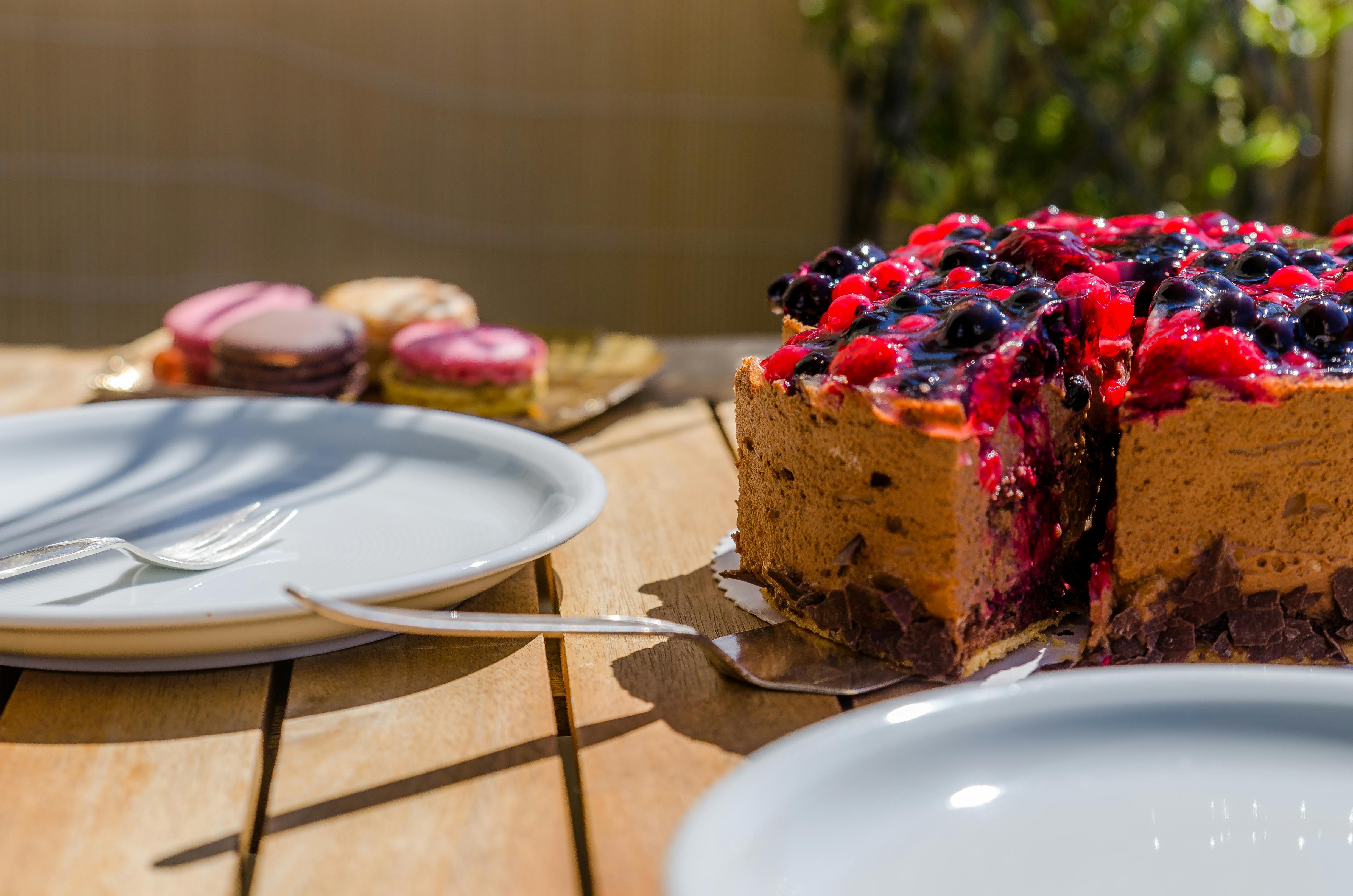 cake near white ceramic plate on brown wooden table