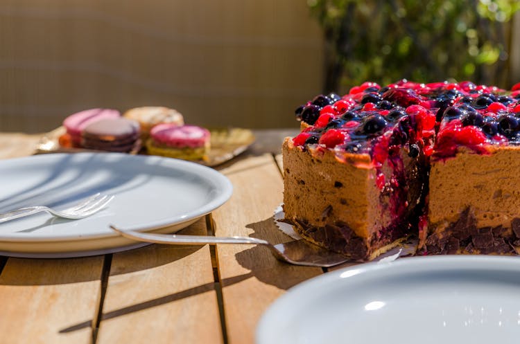 Cake Near White Ceramic Plate On Brown Wooden Table