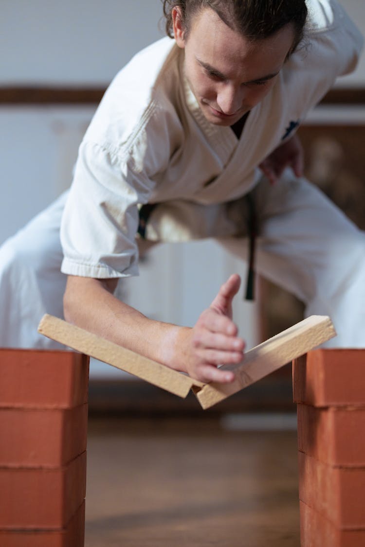 Man Breaking A Board In Martial Arts