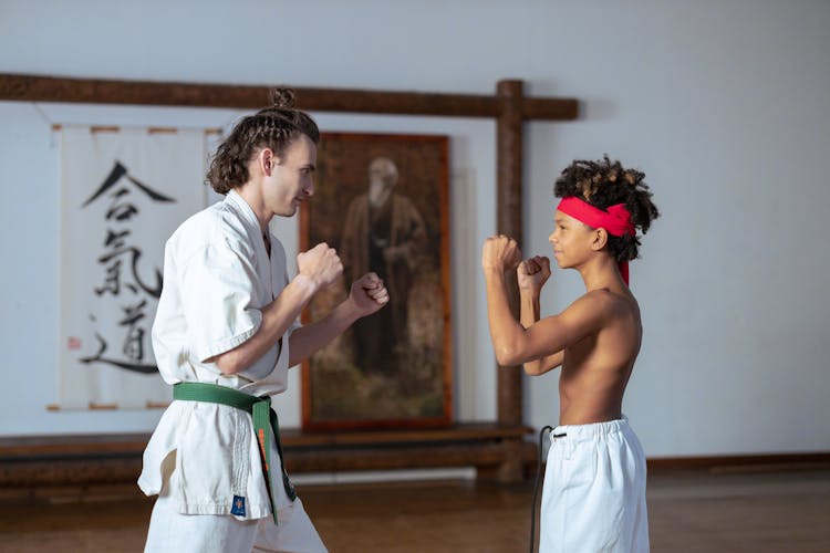 Man Teaching A Boy Karate Stance