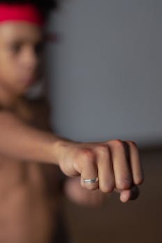 Boy focused on punching technique in martial arts training.