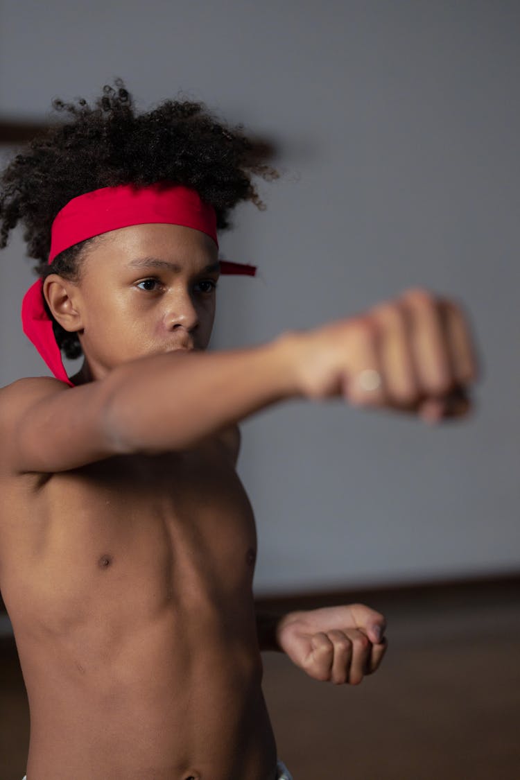 Shirtless Boy Doing A Straight Punch