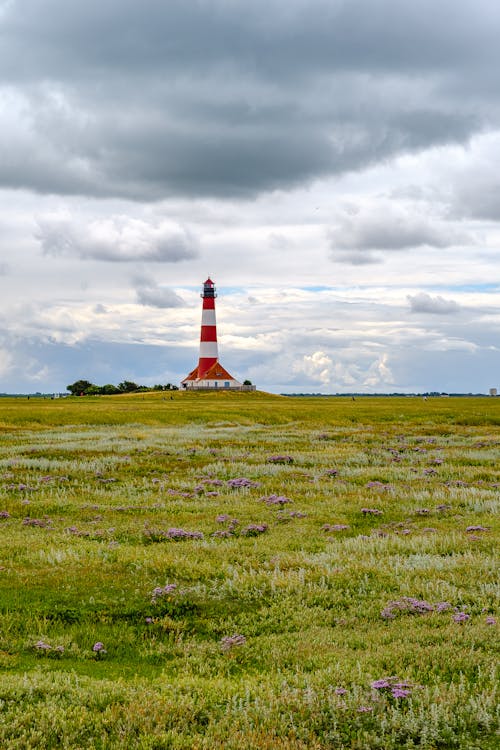 Free Landscape Scenery of an Open Field Across the Lighthouse Stock Photo
