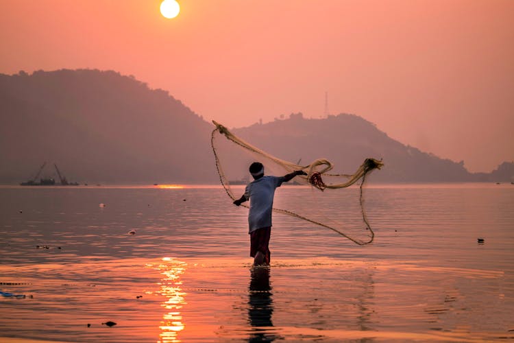 A Fisherman Casting His Fishing Net