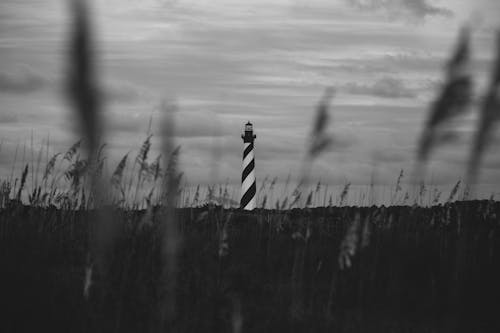 Free Grayscale Photo of a Lighthouse from Afar Stock Photo