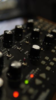 A detailed image of an audio mixer control panel highlighting the knobs and control buttons.