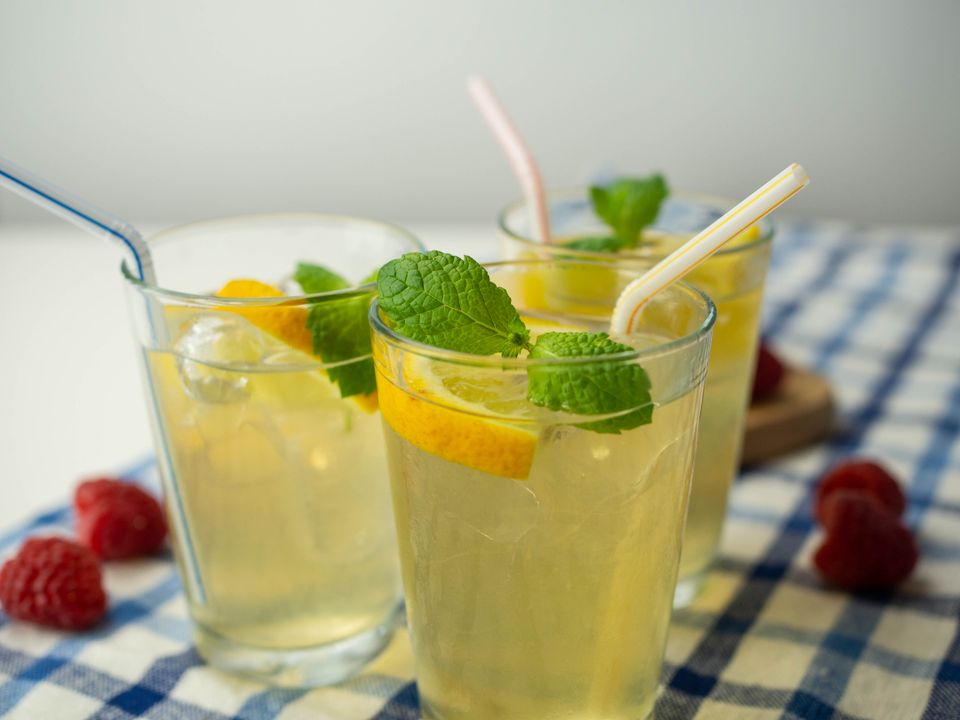 Glasses of iced lemonade with mint on a checked cloth — photo by Mateusz Feliksik on Pexels