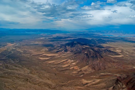 Stunning aerial view capturing the vast and rugged terrain of the Nevada desert under a dramatic sky.