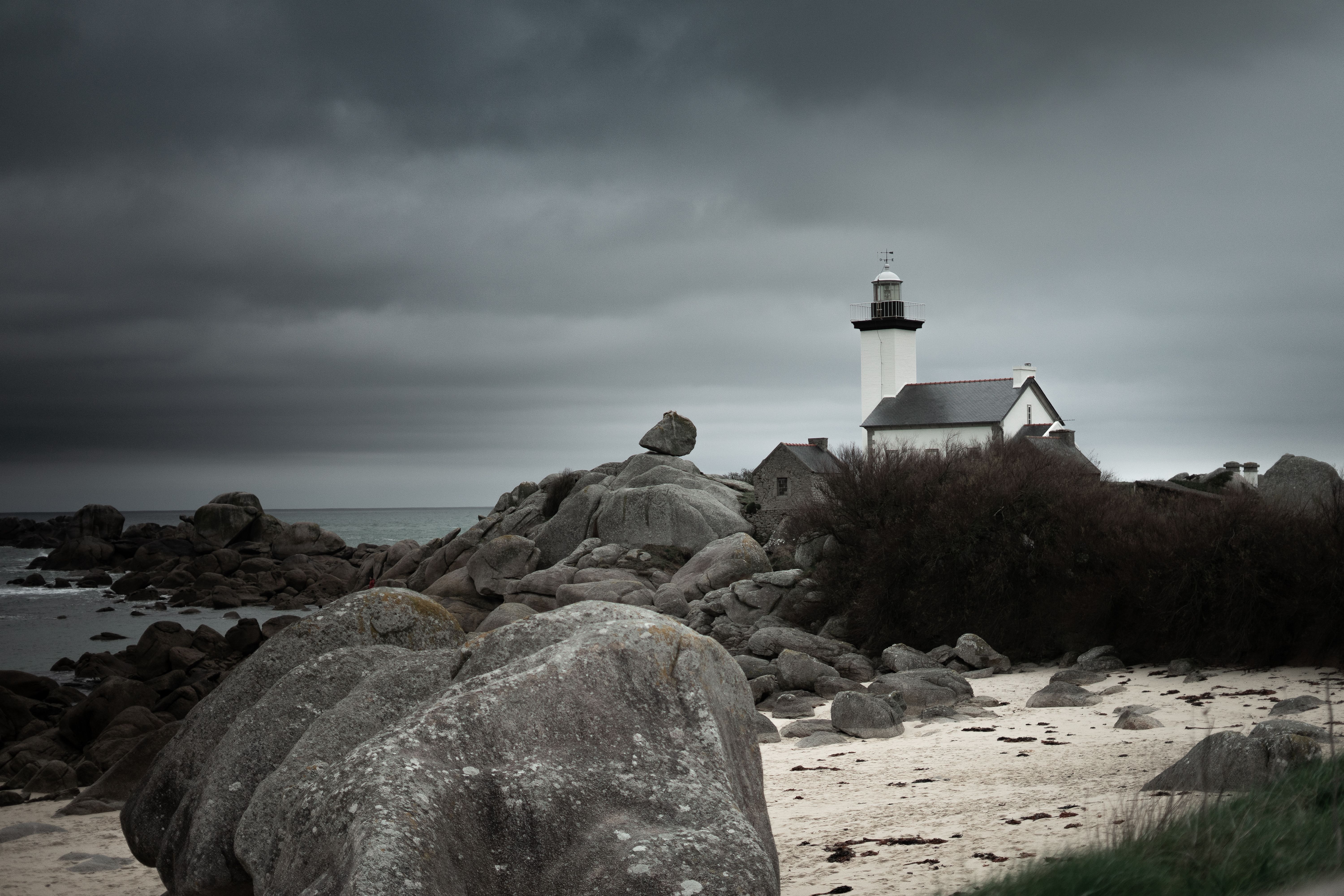 A Lighthouse on a Rocky Shore · Free Stock Photo