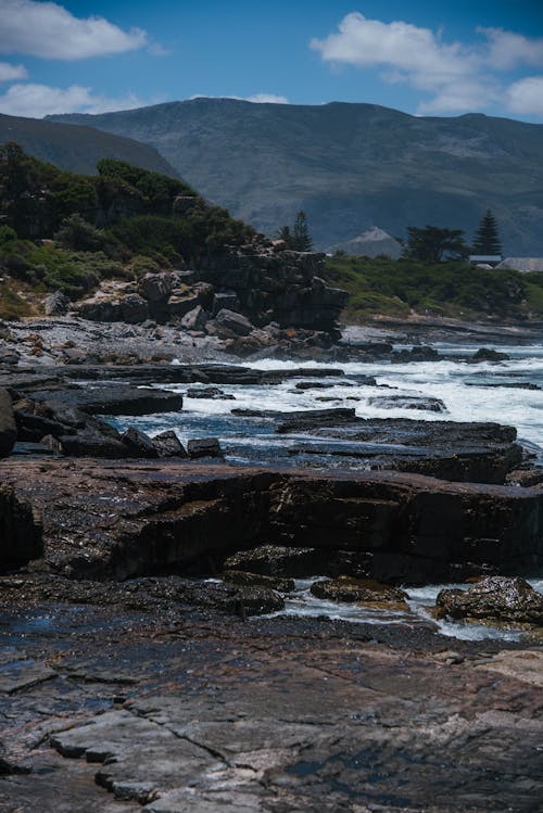 Rocky Coast and Mountains in Distance