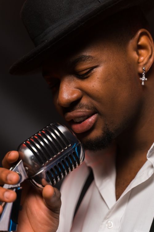 A Singer Holding a Microphone · Free Stock Photo
