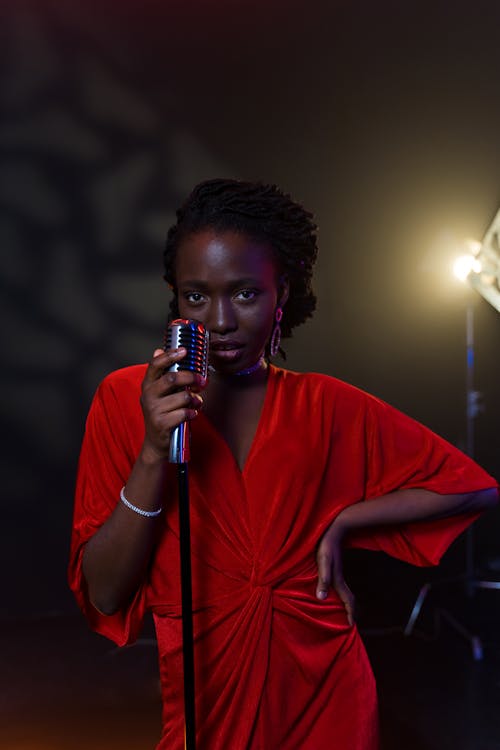 Singer in Red Dress Standing on Stage