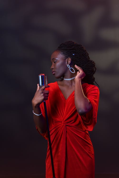 A Female Singer in Red Dress Holding a Microphone