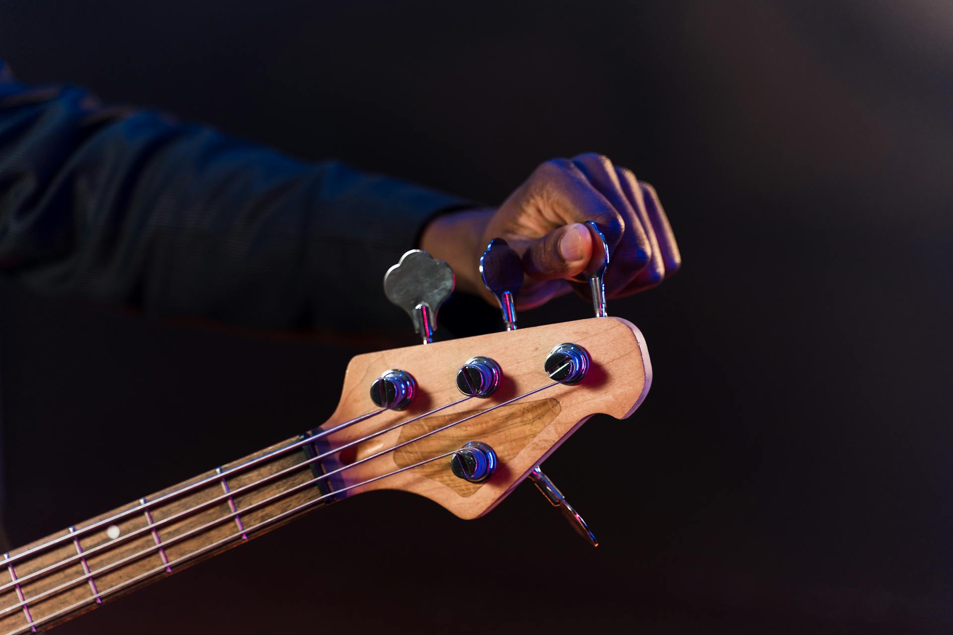 Close-Up Shot of a Person Tuning a Guitar