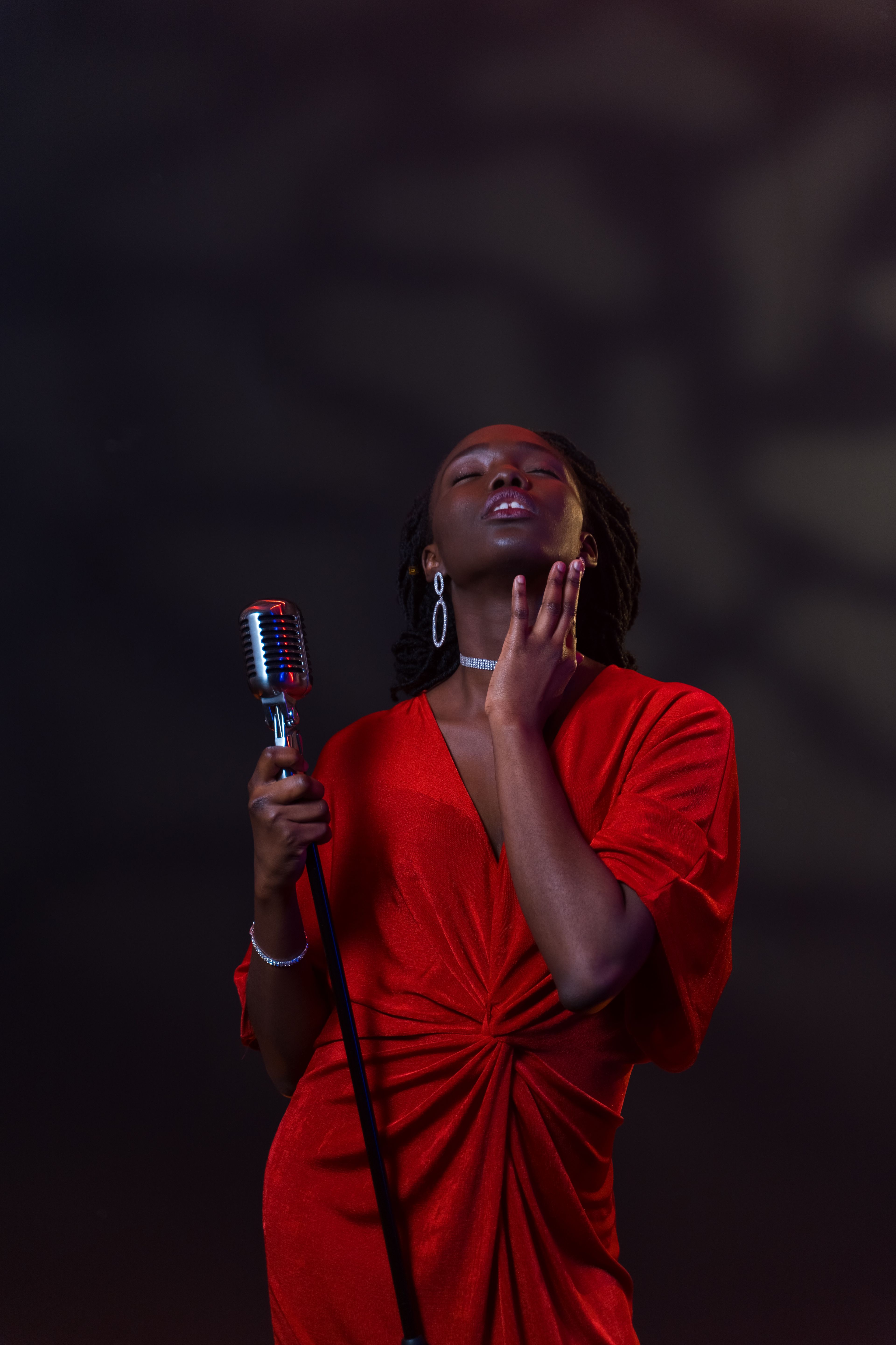 A singer in a red dress performing
