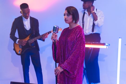 Diverse jazz band performs with lead vocalist in retro style setting