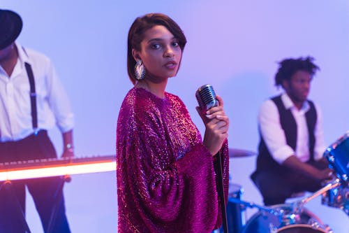 A Female Vocalist in Glittery Dress Singing