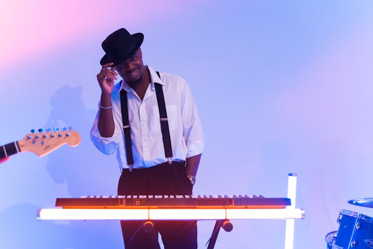 A Male Keyboardist Wearing A Black Hat