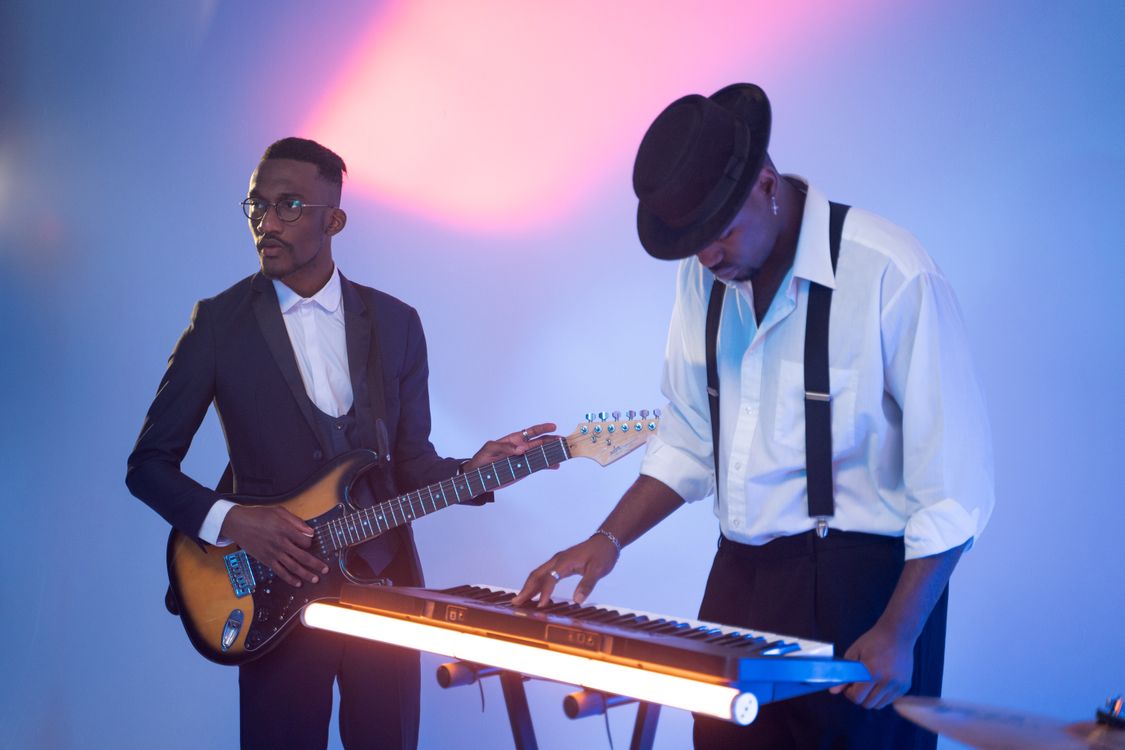 Two Men Playing Music Instruments · Free Stock Photo